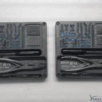 Two identical 1.5mm Cranio Maxillofacial implant system kits with blue titanium fixation plates and forceps side by side