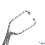 Metal dental instrument with a U-shaped frame and two small hooked tips at ends, shown in close-up.