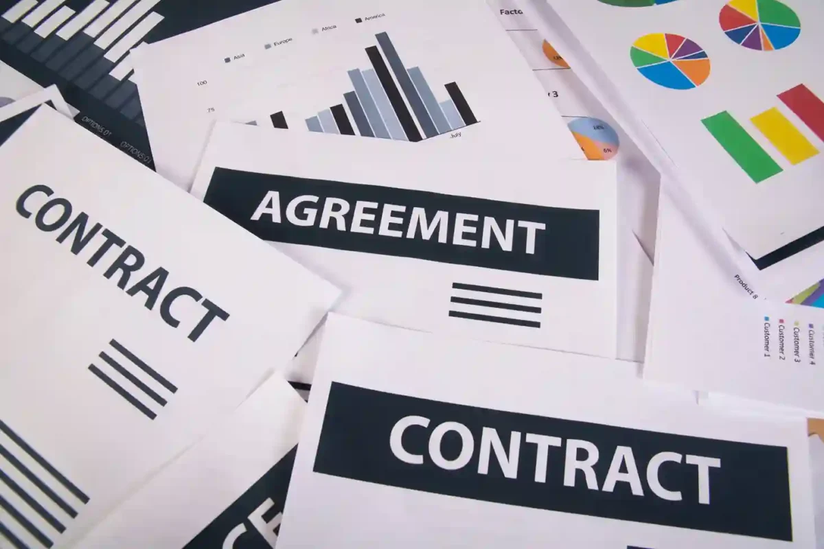 B2B supply agreement and distribution contract documents with financial charts, outlining the legal partnership required to import surgical instruments from Pakistan under strict international regulatory compliance.